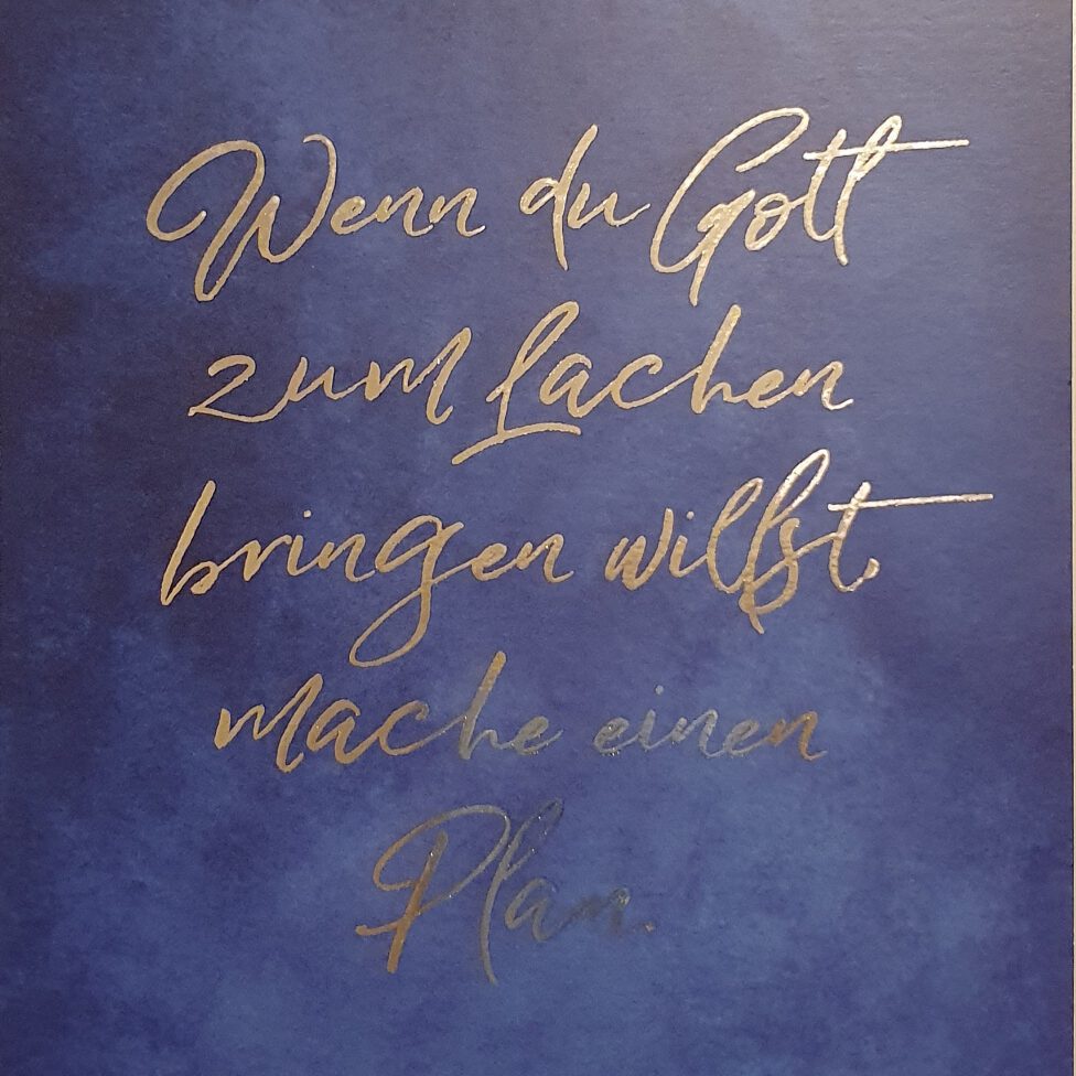 Postkarte mit Zitat „Wenn du Gott zum Lachen bringen willst, dann mache einen Plan.“ – Symbol für Vertrauen und göttliche Führung.